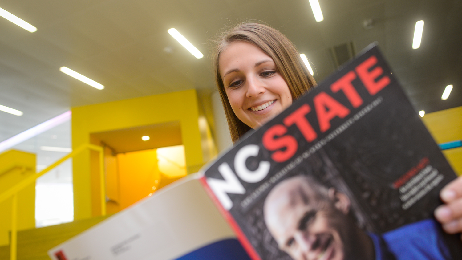 Student reads NC State magazine