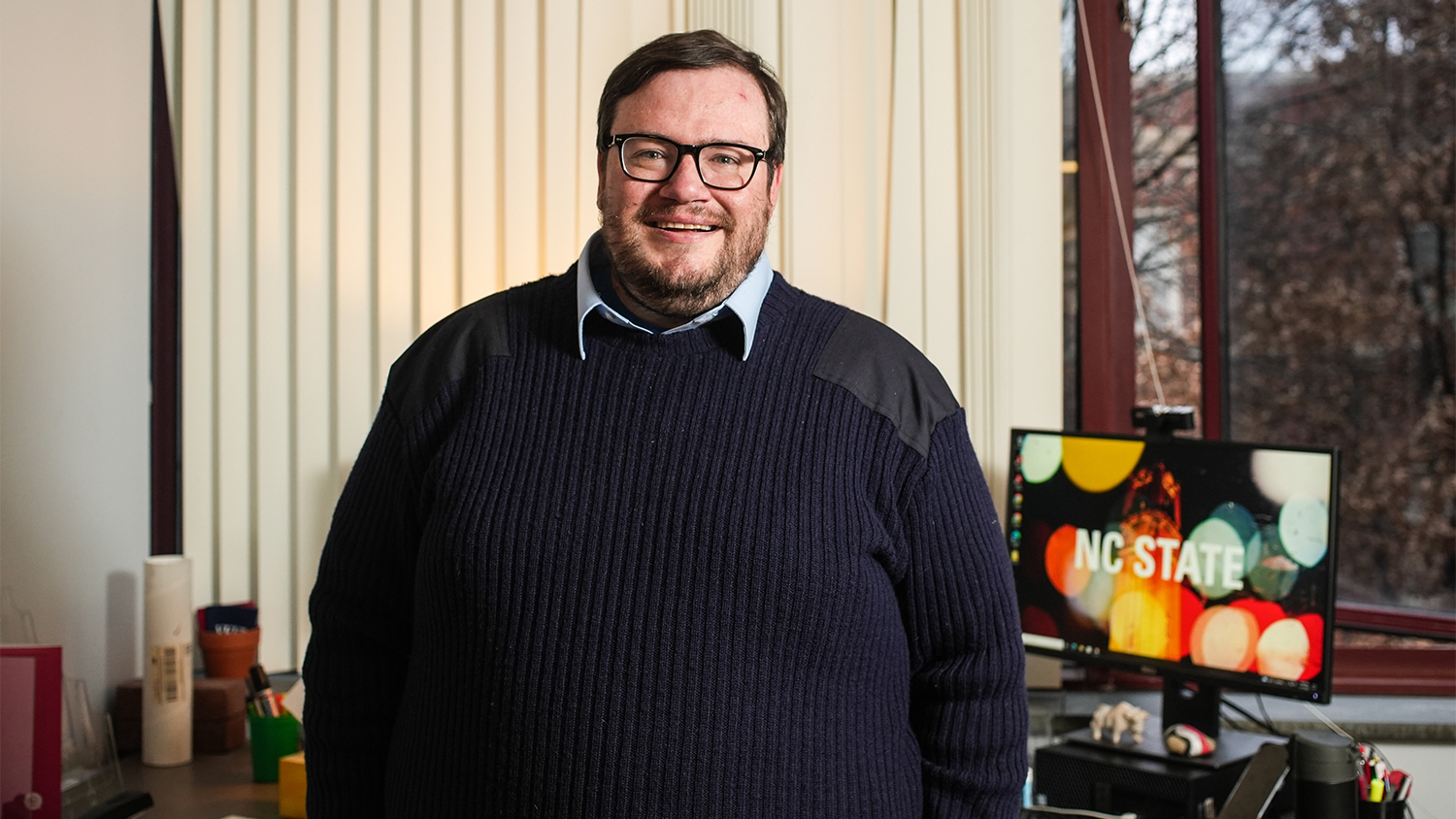 Ben McNeely in his office, with a computer behind him