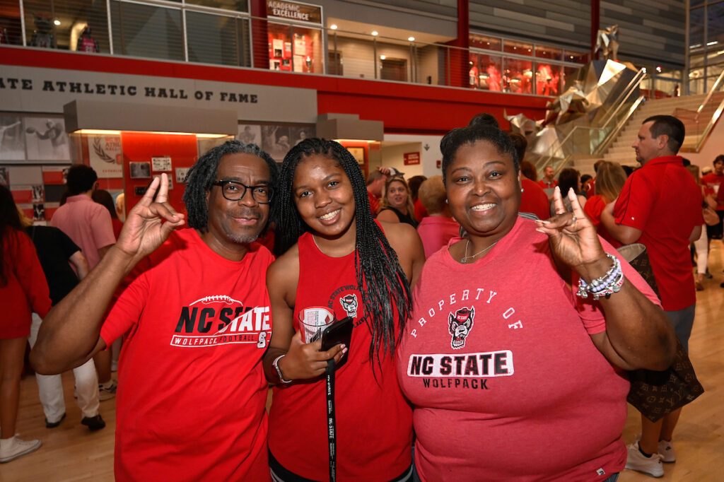 A family poses for a photo at the Legacy Lunch in Reynolds coliseum. 