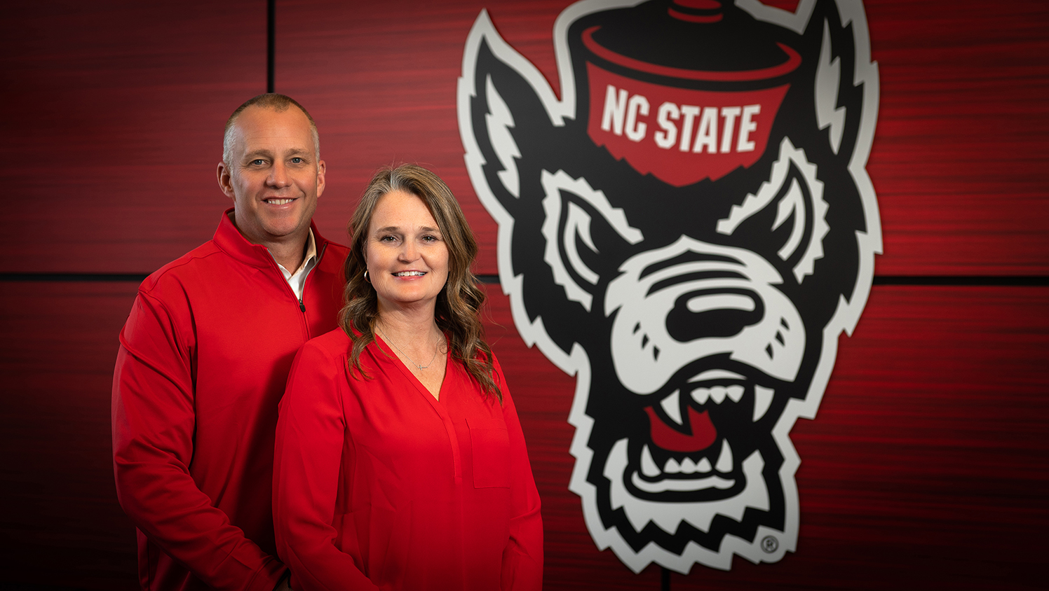 Dave and Sara Doeren in front of the Tuffy logo