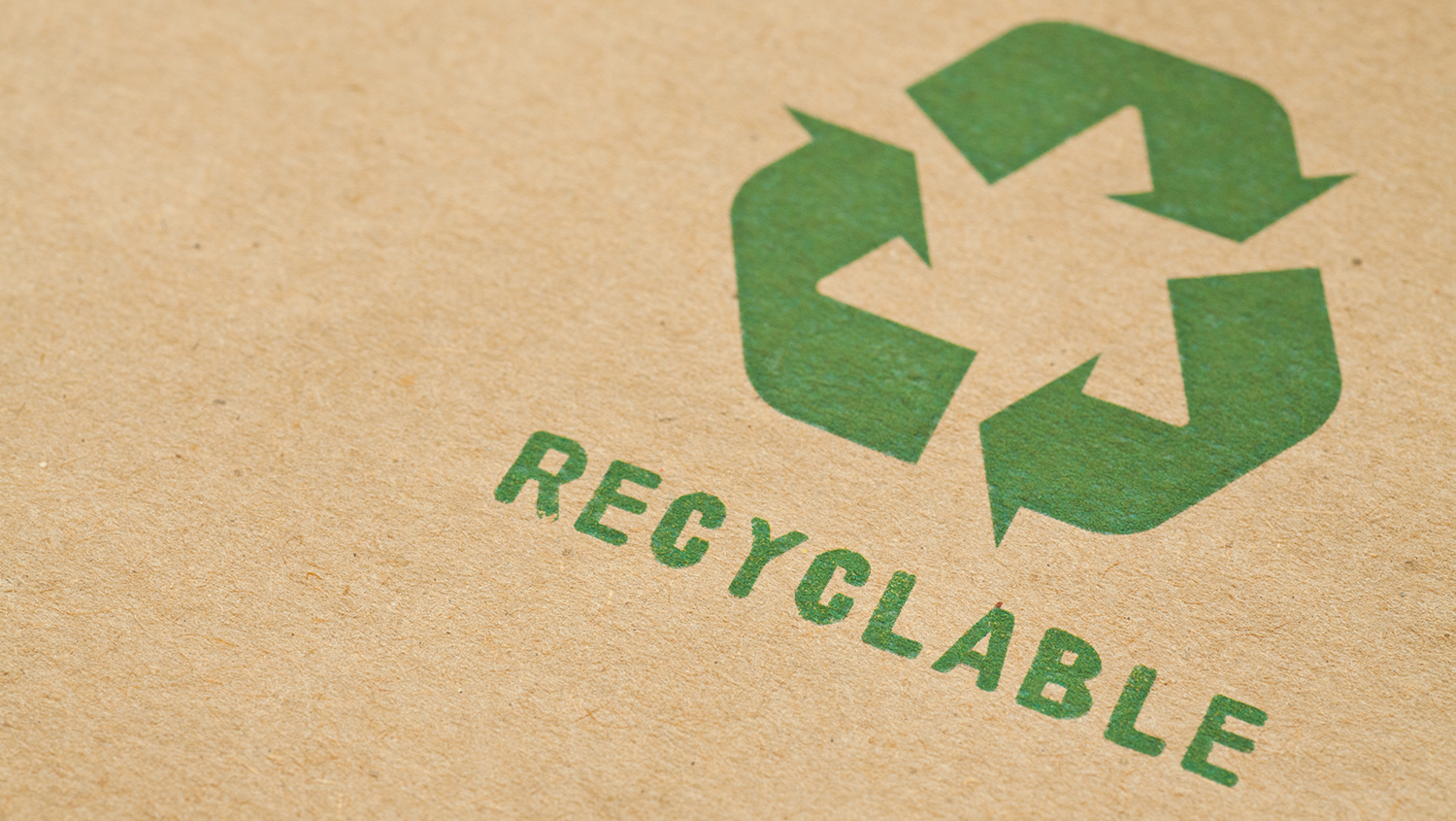 Green recycle symbol on cardboard