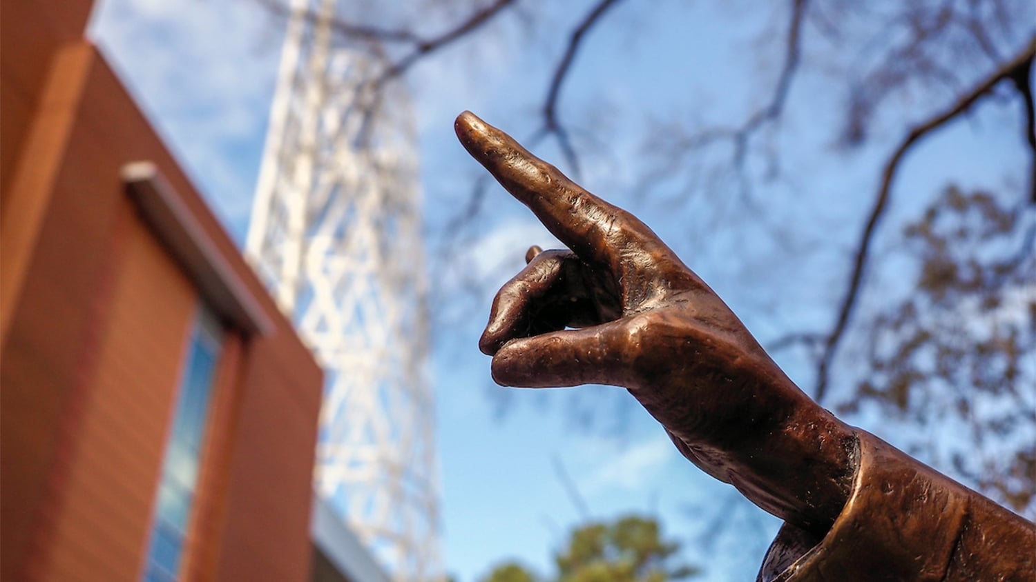 The fingers on Kay Yow's statue outside of Reynolds Coliseum make a wolfie sign