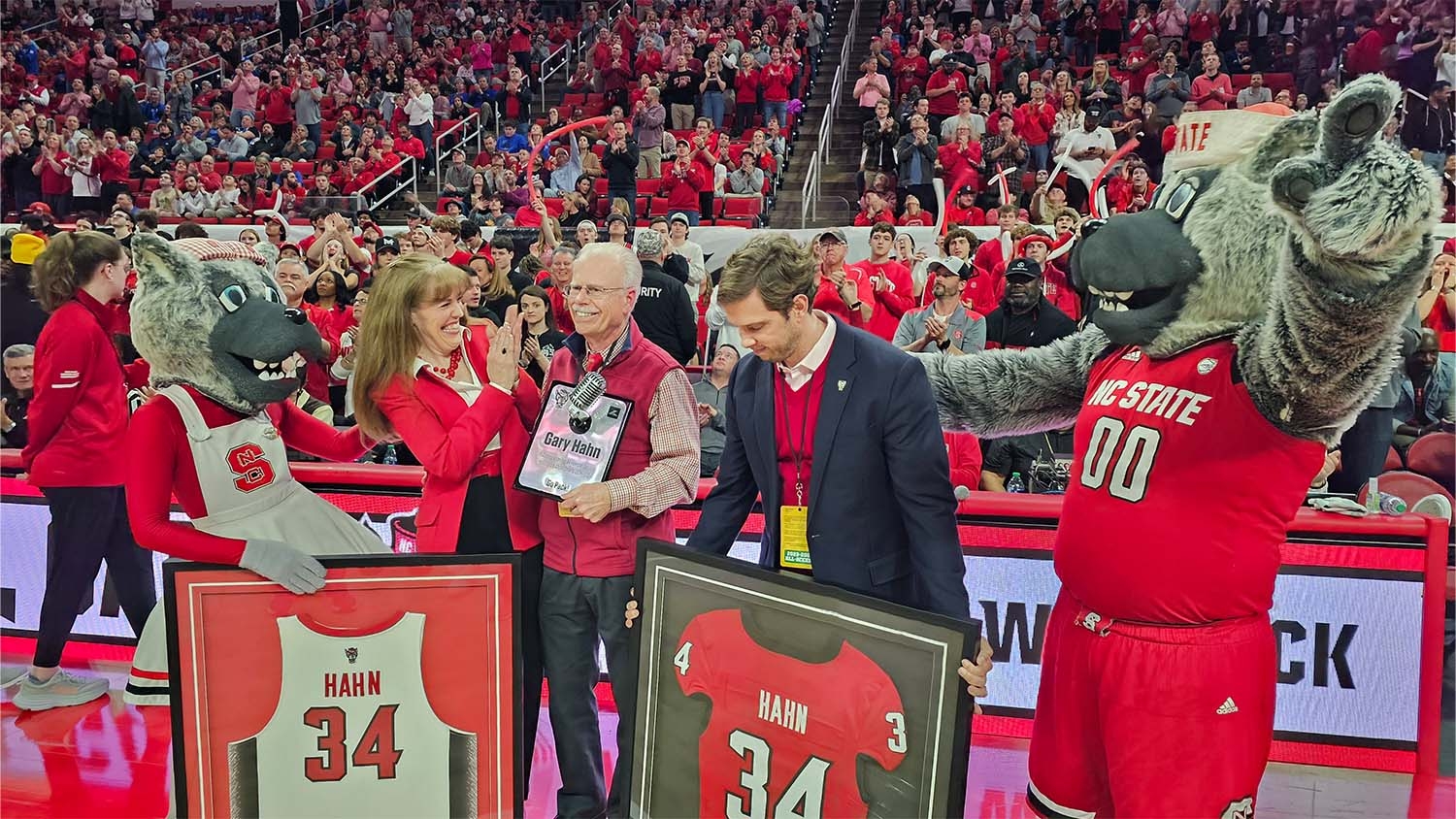 Gary Hahn is recognized on the court of PNC Arena after calling his last men's basketball game earlier this week.