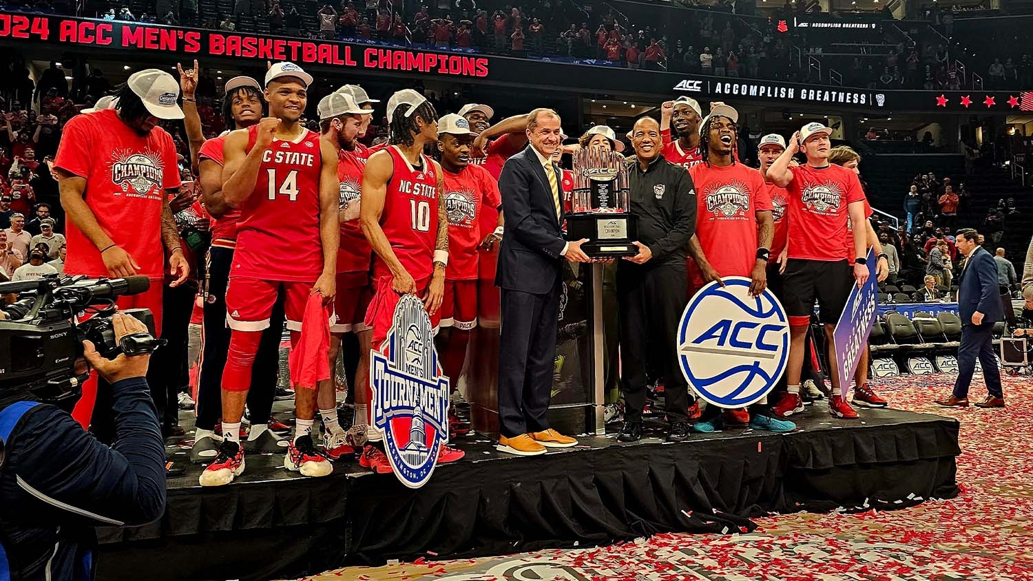 NC State's men's basketball team earns its ACC Championship trophy on stage after the game
