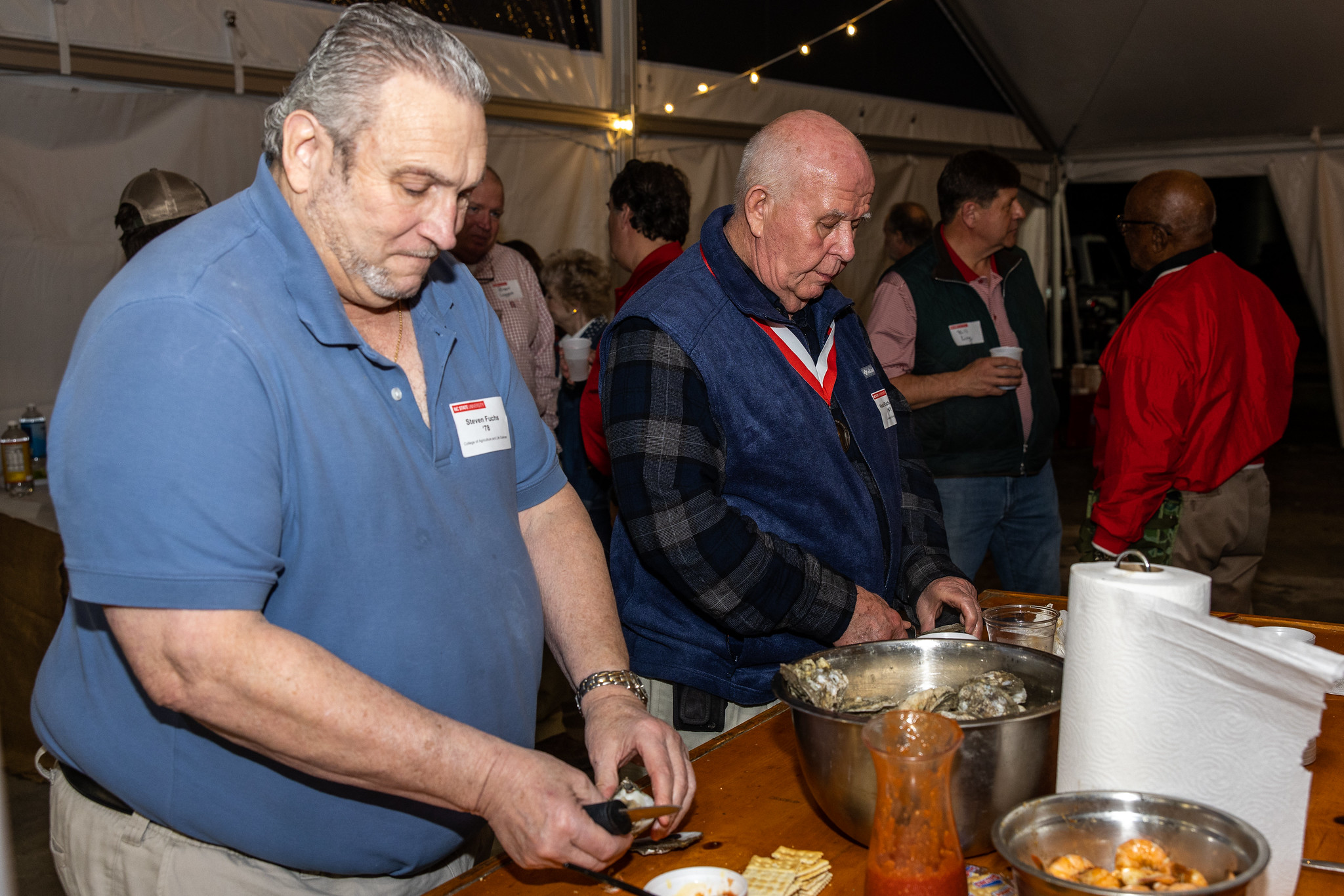 Beaufort County Oyster Roast attendees shuck oysters
