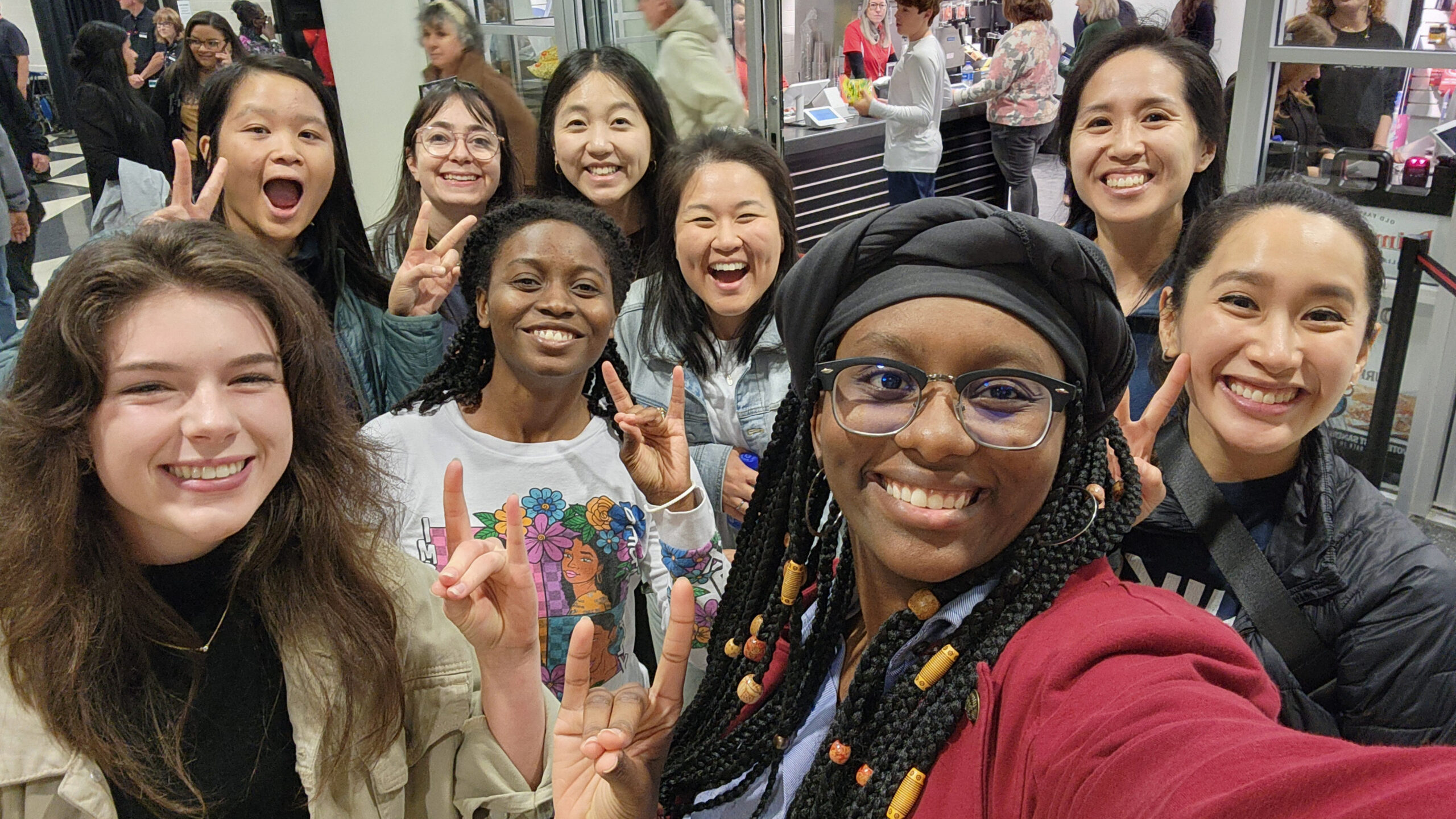 Tabitha Gardner '23 '24 and other NC State students and alumni go Wolfies Up for a selfie.
