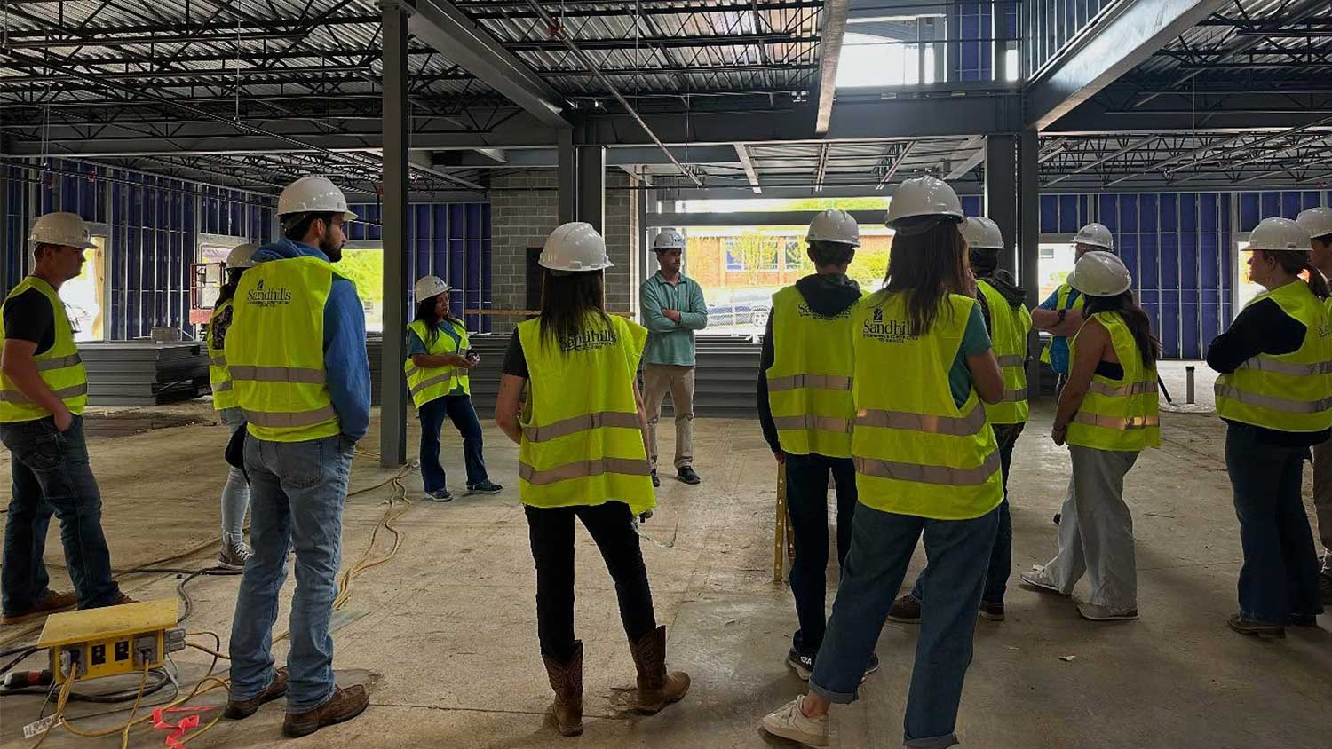 Students from Sandhills Community College observe the construction of the LKC Engineering office building in Southern Pines.
